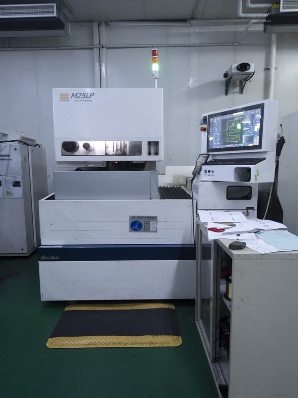 Mold technician repairing injection mold